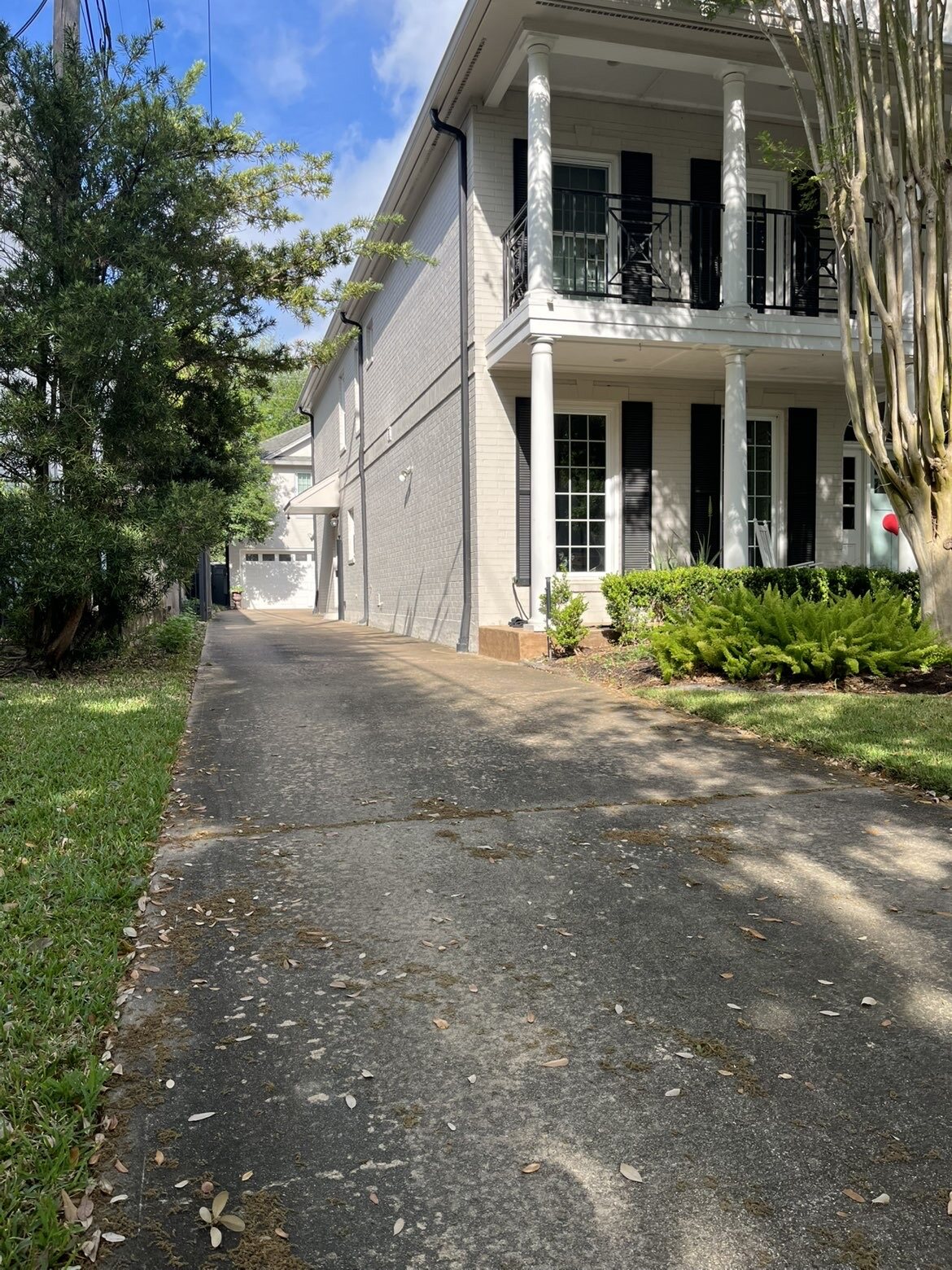 Stained residential driveway before pressure washing