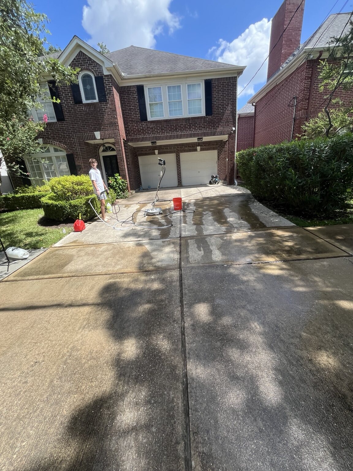 Driveway pressure washing in progress