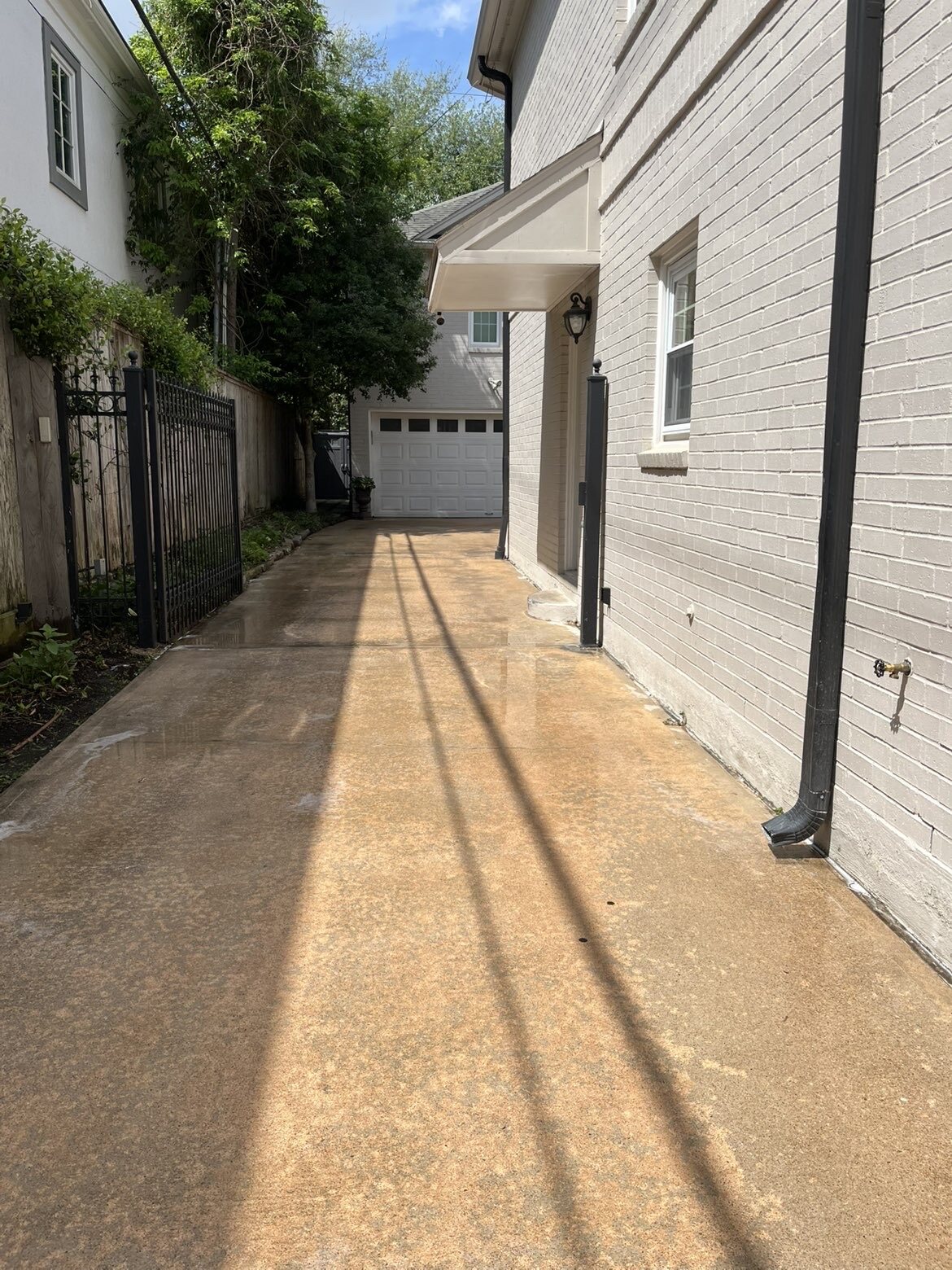 Cleaned residential side driveway leading to a detached garage