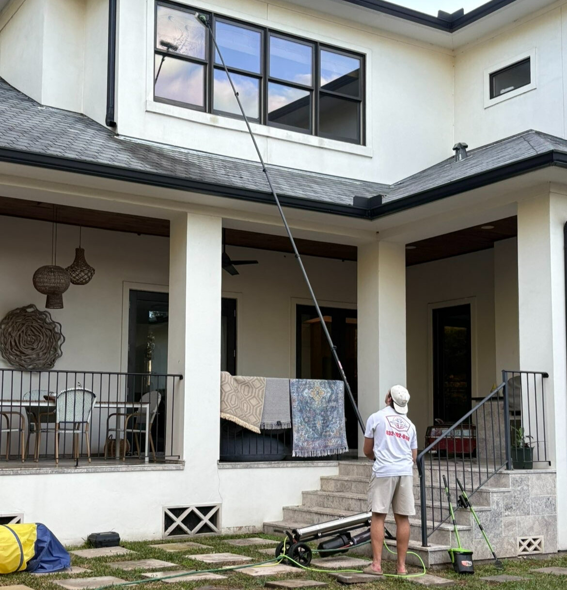 Bellaire Pro Wash technician cleaning windows at a Houston-area home